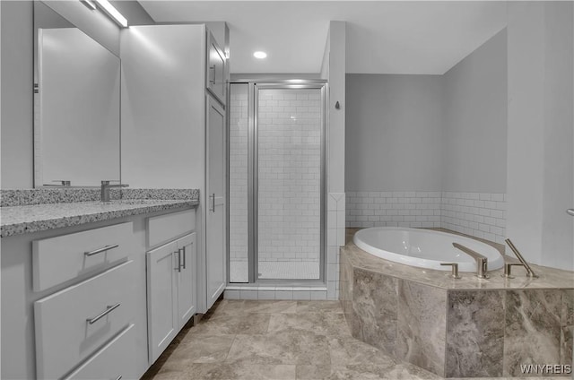 bathroom featuring tile patterned flooring, vanity, and plus walk in shower