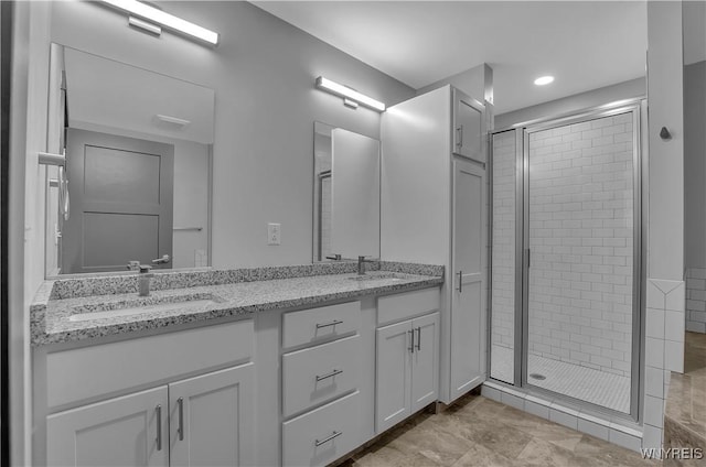 bathroom with vanity and a shower with shower door