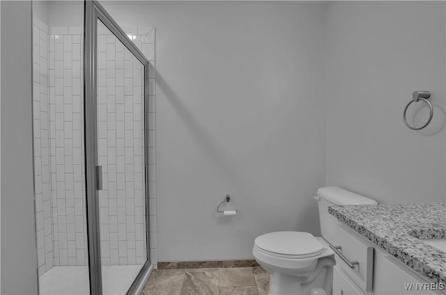 bathroom featuring an enclosed shower, vanity, and toilet