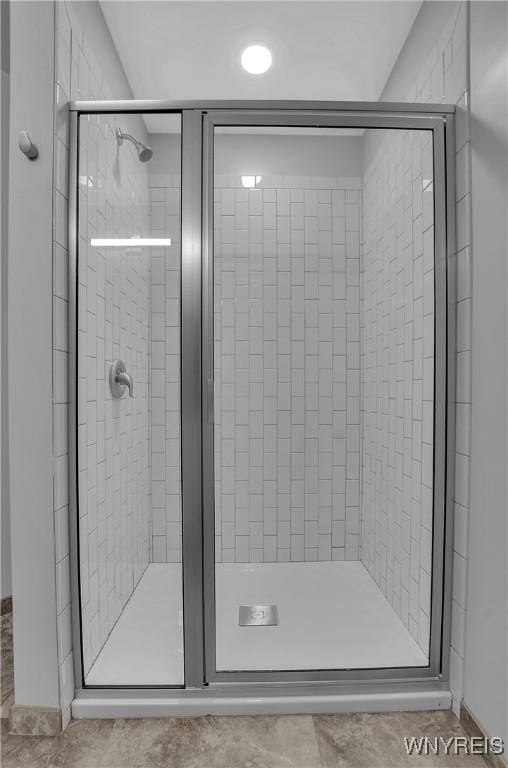 bathroom featuring tile patterned floors and a shower with shower door