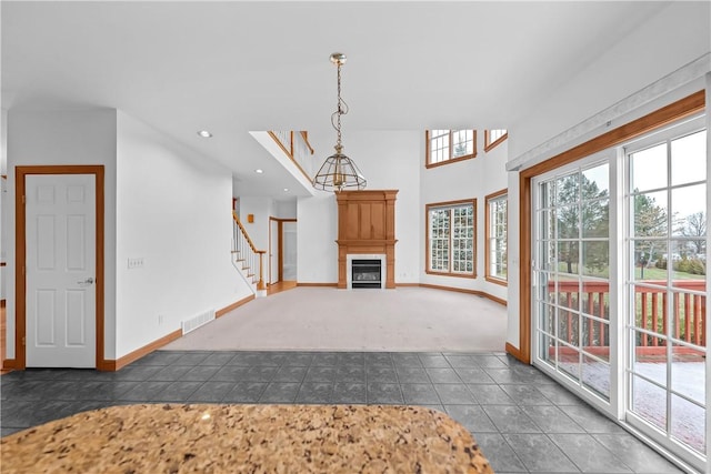 unfurnished living room featuring dark tile patterned floors