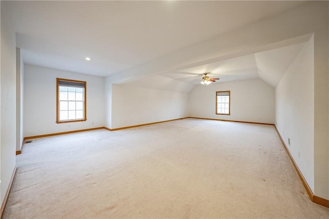 bonus room featuring ceiling fan, lofted ceiling, and light carpet