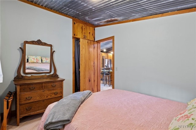 bedroom featuring stainless steel fridge