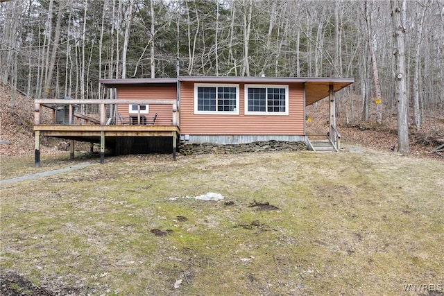 view of front of house featuring a front lawn and a wooden deck