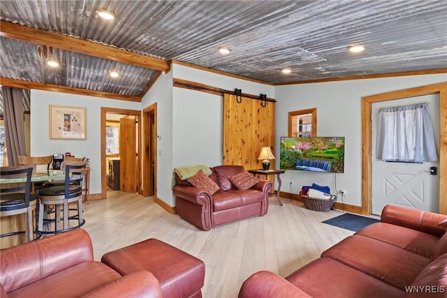 living area with a barn door, recessed lighting, wood finished floors, and baseboards