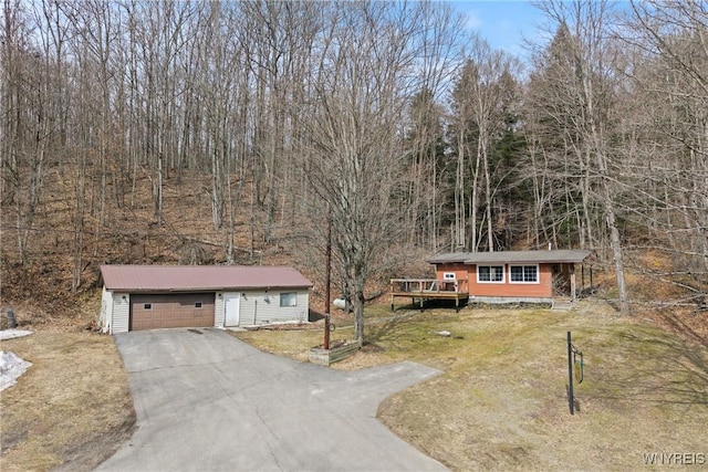 view of front of house with a garage, an outbuilding, and a front yard