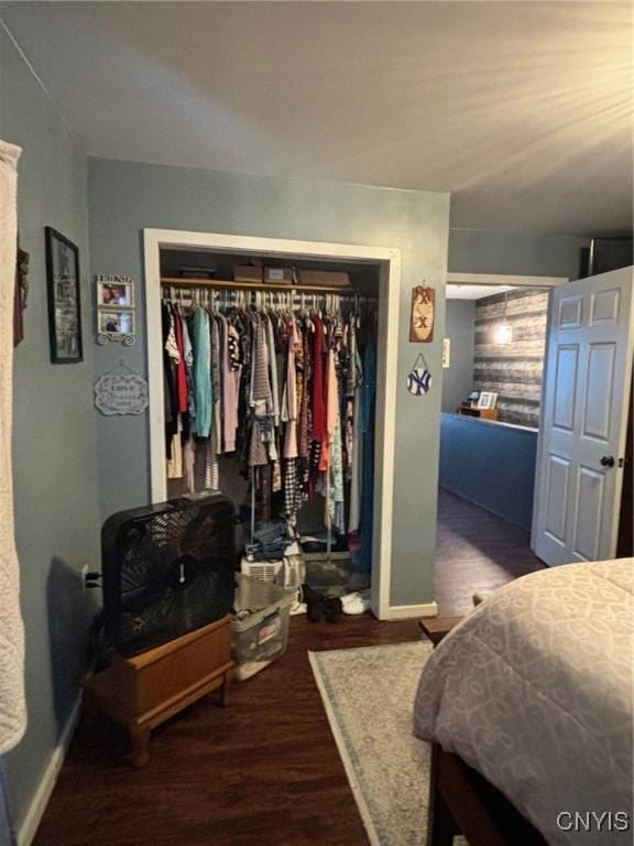 bedroom featuring dark hardwood / wood-style flooring and a closet