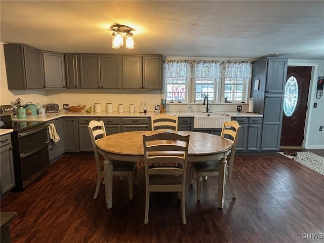 kitchen featuring gray cabinetry, dark hardwood / wood-style floors, sink, and black / electric stove