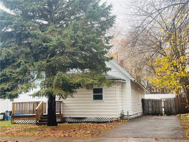 view of property exterior with a wooden deck