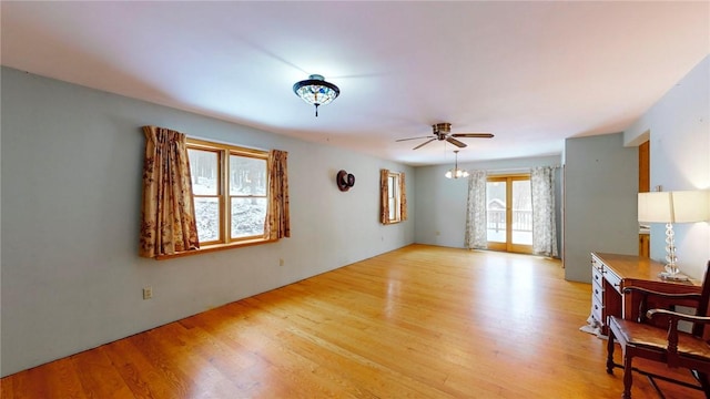 living room featuring ceiling fan and light hardwood / wood-style floors