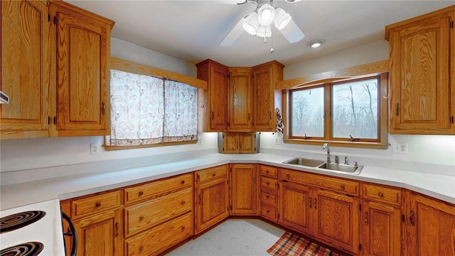 kitchen with ceiling fan, sink, and white stove