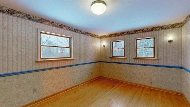 unfurnished room with wood-type flooring