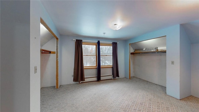 unfurnished bedroom featuring a closet, light carpet, and a baseboard heating unit