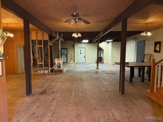 basement featuring hardwood / wood-style flooring and ceiling fan