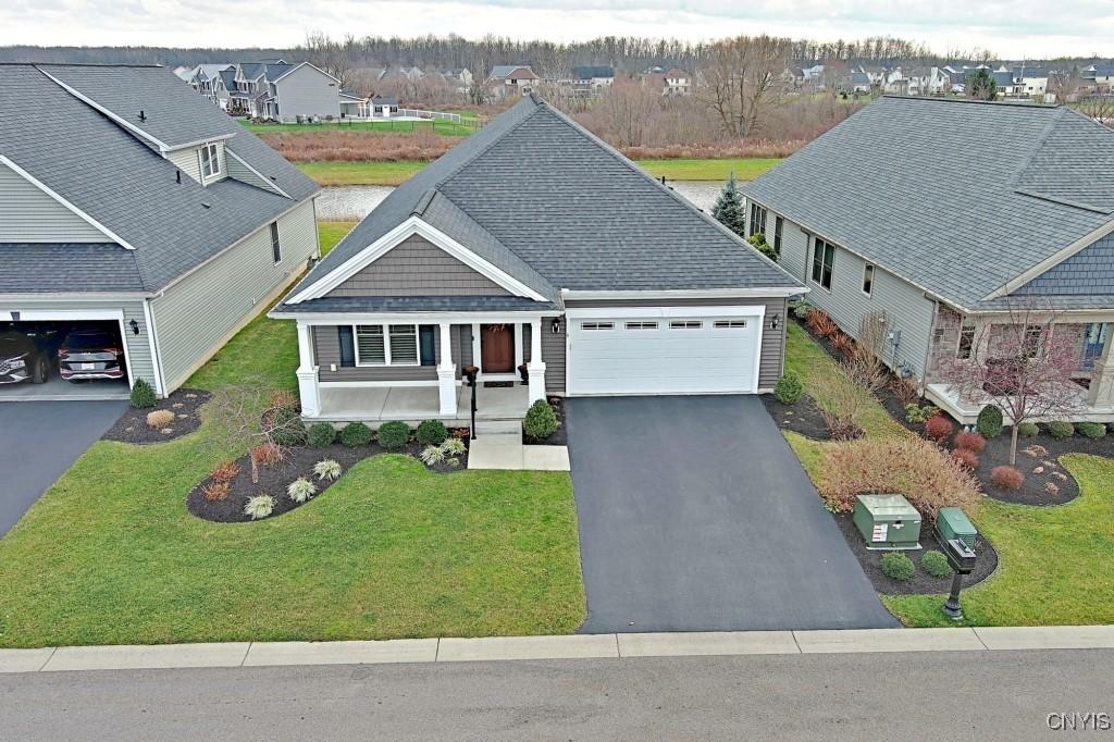 6 Saybrook Dr, Lancaster, NY 14086 - view of front of house featuring covered porch, a garage, and a front lawn