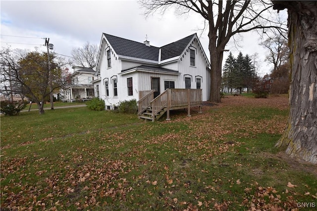 view of side of home with a lawn and a wooden deck