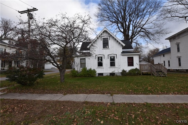 view of front of home with a wooden deck and a front yard