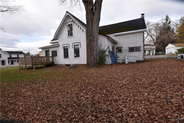 back of house with a deck