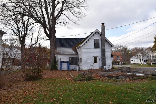 rear view of house featuring a yard