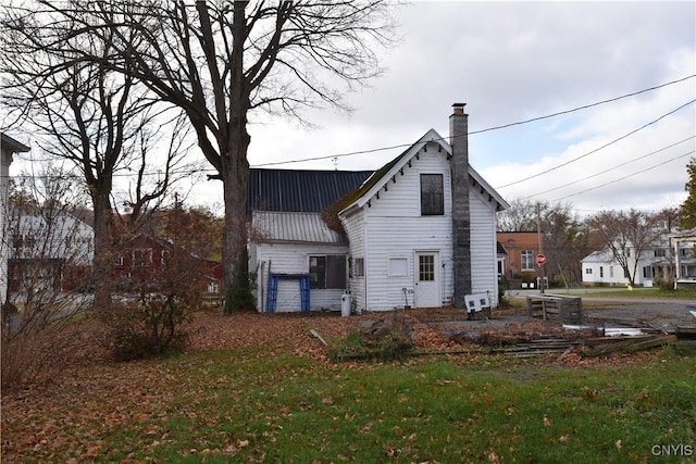 228 Main St, Theresa, NY 13691 - rear view of property with a chimney and a metal roof