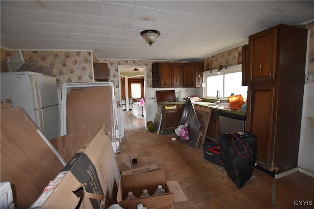 228 Main St, Theresa, NY 13691 - kitchen featuring healthy amount of natural light, wallpapered walls, freestanding refrigerator, open shelves, and fridge