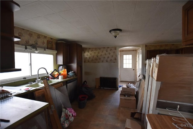 228 Main St, Theresa, NY 13691 - kitchen featuring wallpapered walls, radiator heating unit, a wainscoted wall, tile patterned floors, and light countertops