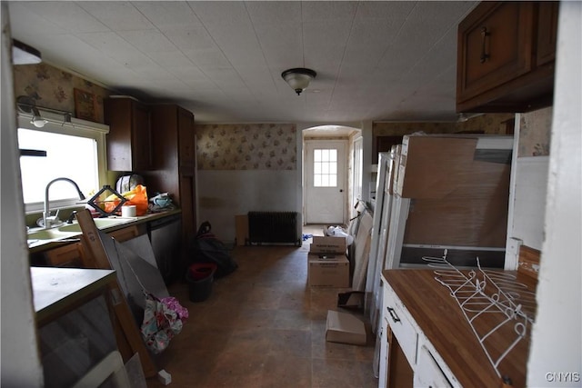 228 Main St, Theresa, NY 13691 - kitchen with butcher block counters, radiator heating unit, wallpapered walls, and dishwasher