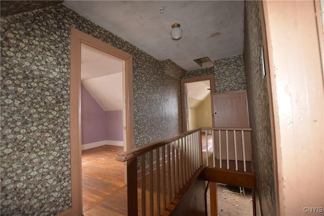 228 Main St, Theresa, NY 13691 - staircase featuring lofted ceiling, wallpapered walls, and wood finished floors