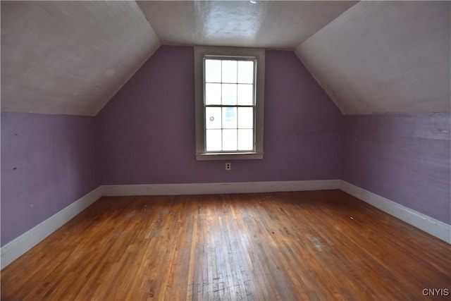 bonus room featuring lofted ceiling and hardwood / wood-style flooring