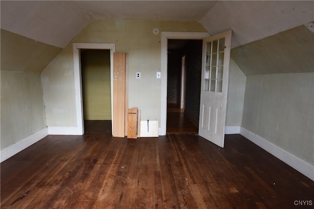 additional living space with dark hardwood / wood-style flooring and vaulted ceiling