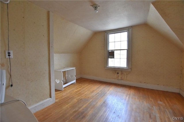 bonus room featuring light hardwood / wood-style floors and lofted ceiling