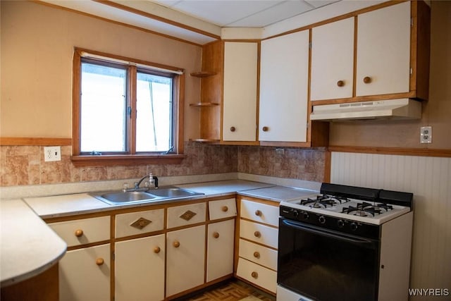 kitchen featuring white range with gas stovetop, dark parquet flooring, white cabinetry, and sink