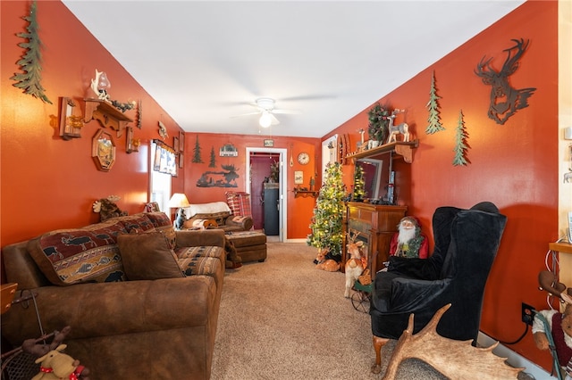 living room with carpet, a fireplace, and ceiling fan