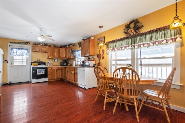 dining room with plenty of natural light, baseboards, and dark wood-type flooring