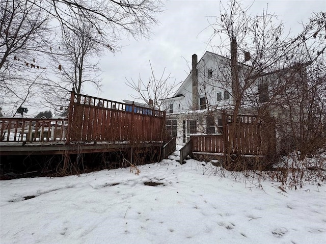 snowy yard featuring a deck