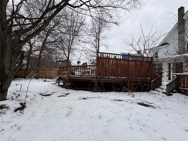 yard layered in snow featuring a wooden deck