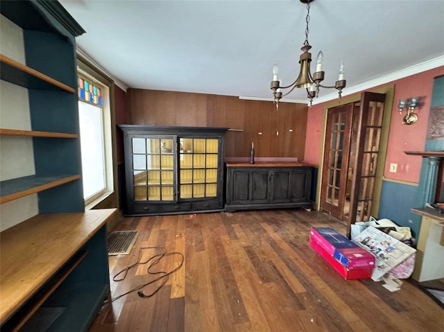 interior space featuring a chandelier, dark hardwood / wood-style floors, and crown molding