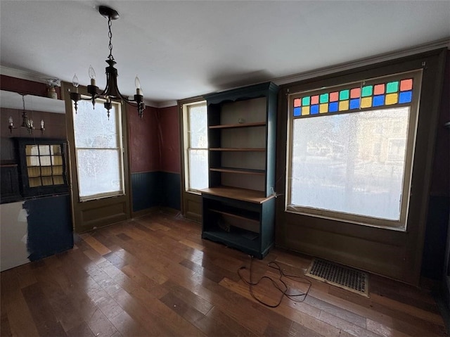 unfurnished dining area with dark hardwood / wood-style floors and a notable chandelier