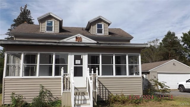 view of front of home with a garage and an outdoor structure