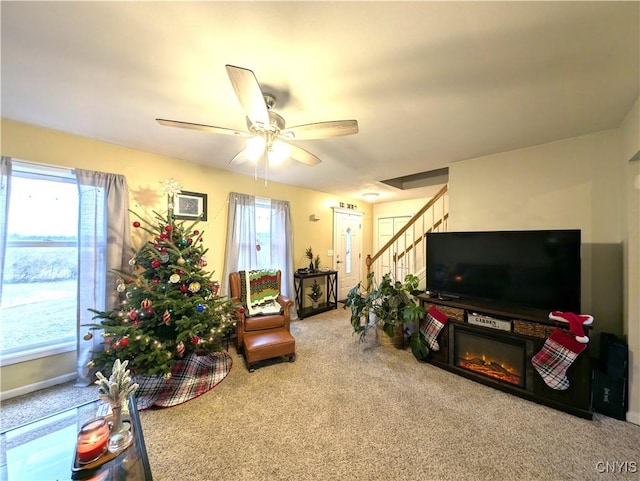 carpeted living room featuring a wealth of natural light and ceiling fan