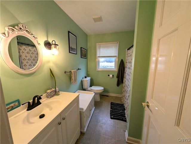 bathroom featuring tile patterned floors, vanity, and toilet