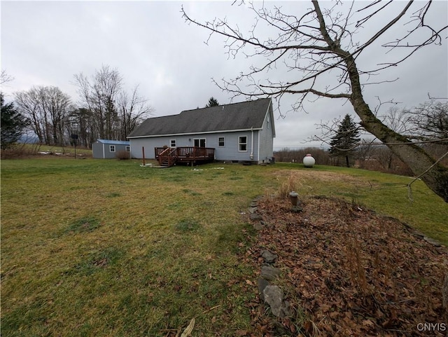 back of house with a lawn and a deck