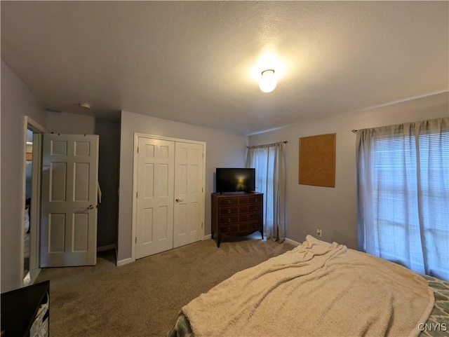 bedroom featuring carpet, a textured ceiling, and a closet