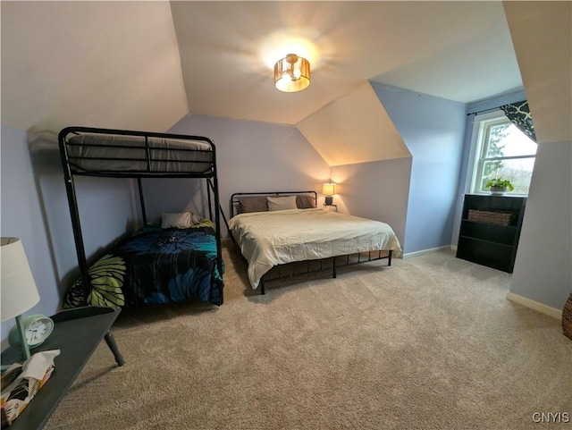 carpeted bedroom featuring vaulted ceiling