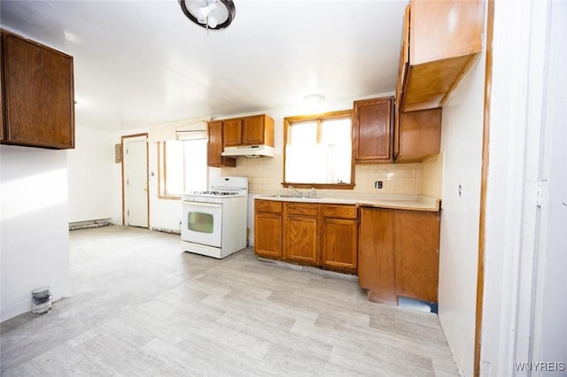 kitchen with sink, backsplash, and gas range gas stove