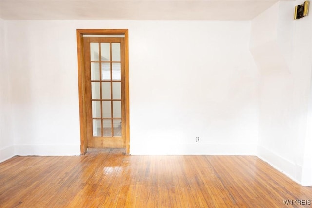 unfurnished room featuring hardwood / wood-style floors