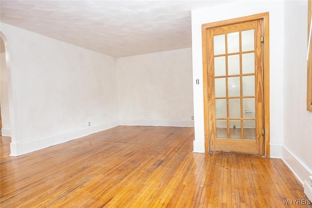 empty room with light hardwood / wood-style flooring