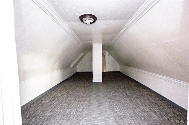 bonus room featuring dark carpet and lofted ceiling