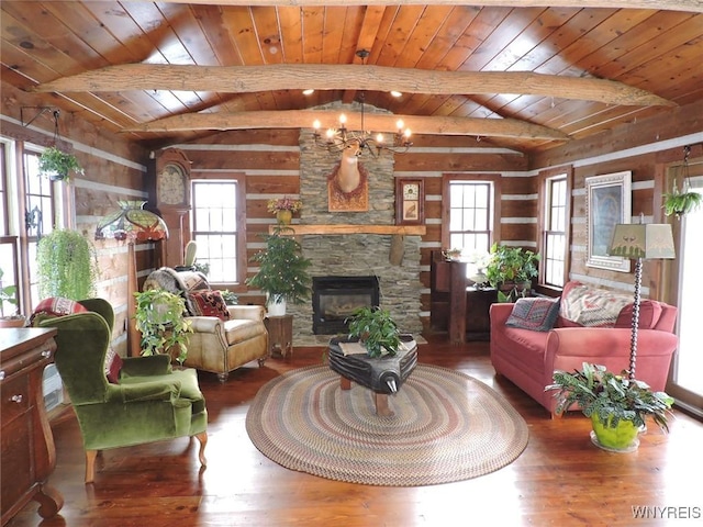 living room with wooden ceiling, vaulted ceiling with beams, a stone fireplace, a notable chandelier, and wood-type flooring