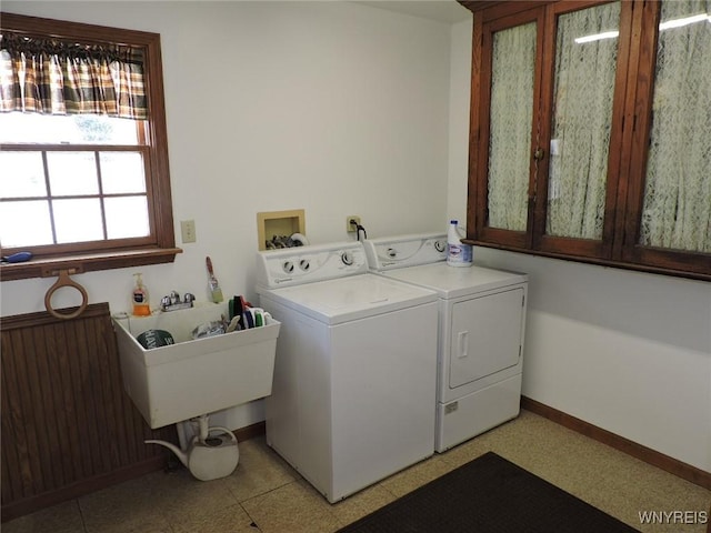 clothes washing area featuring washer and dryer, cabinets, sink, and radiator